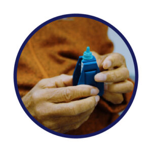 an assistive device to give extra leverage when squeezing an eye drop bottle